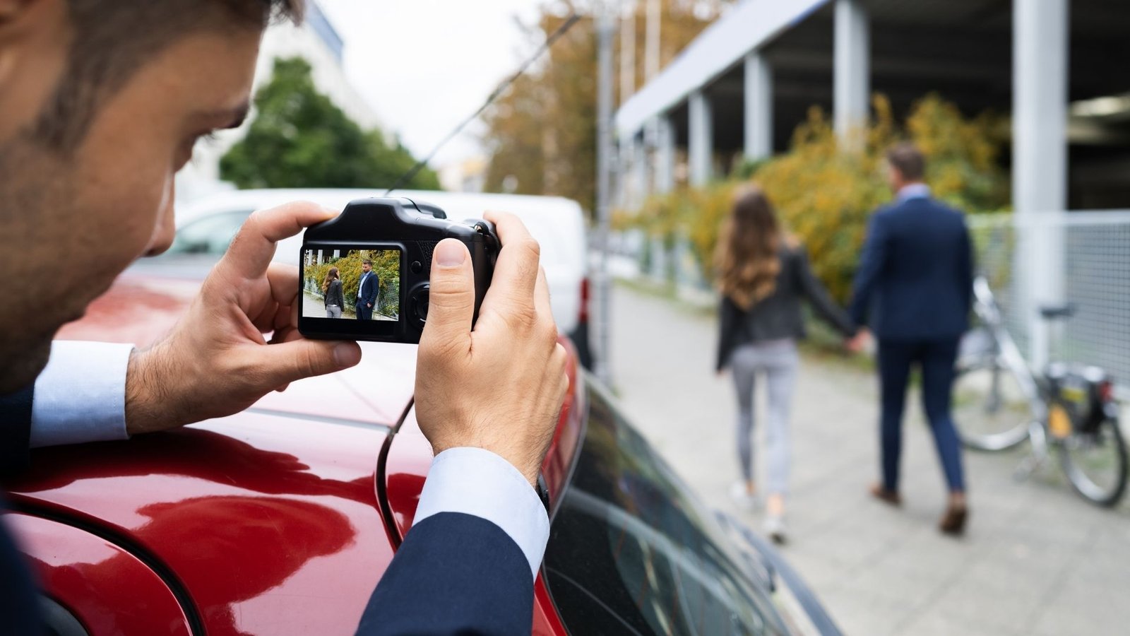 PI with cam Infidelity Infidelity Investigator conducting discreet surveillance investigation for an infidelity case.